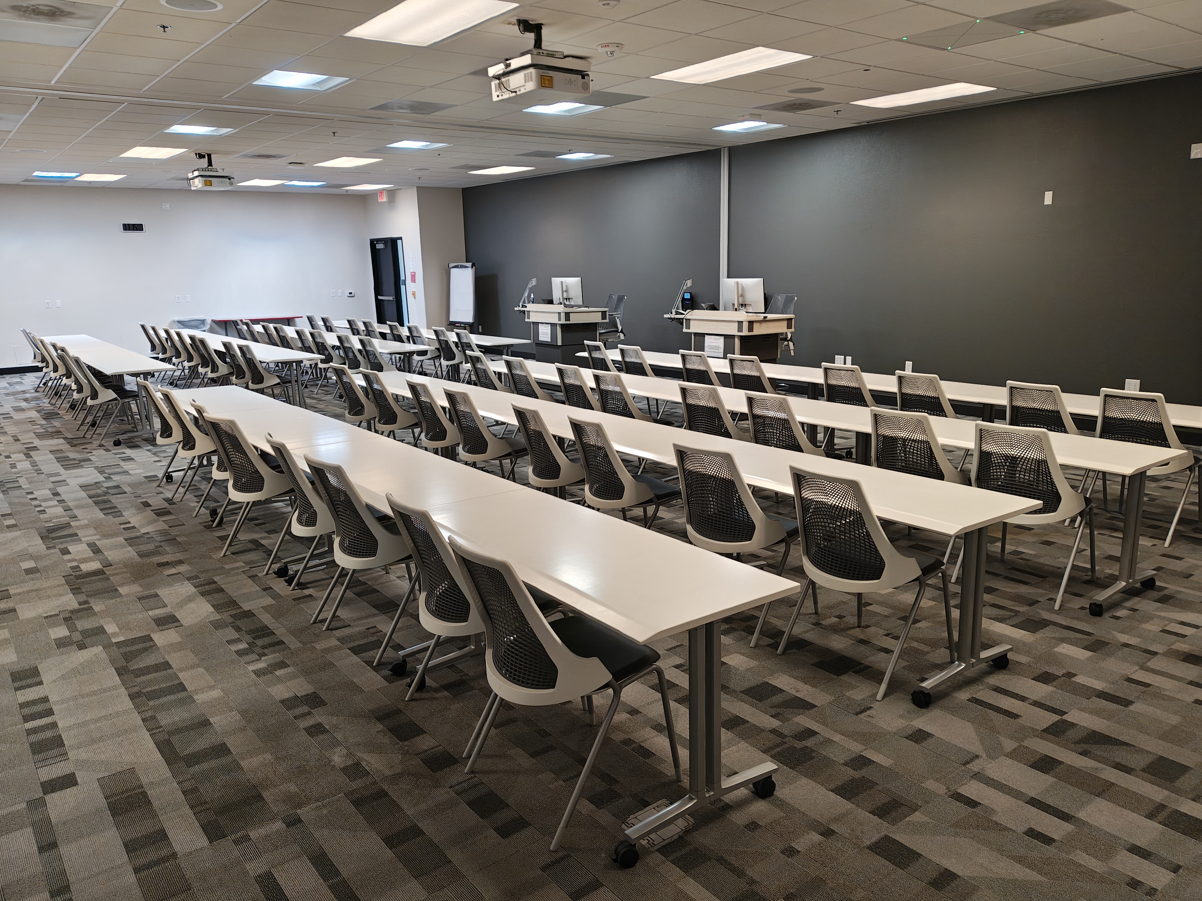 Room 138-139 with rows of chairs and tables 