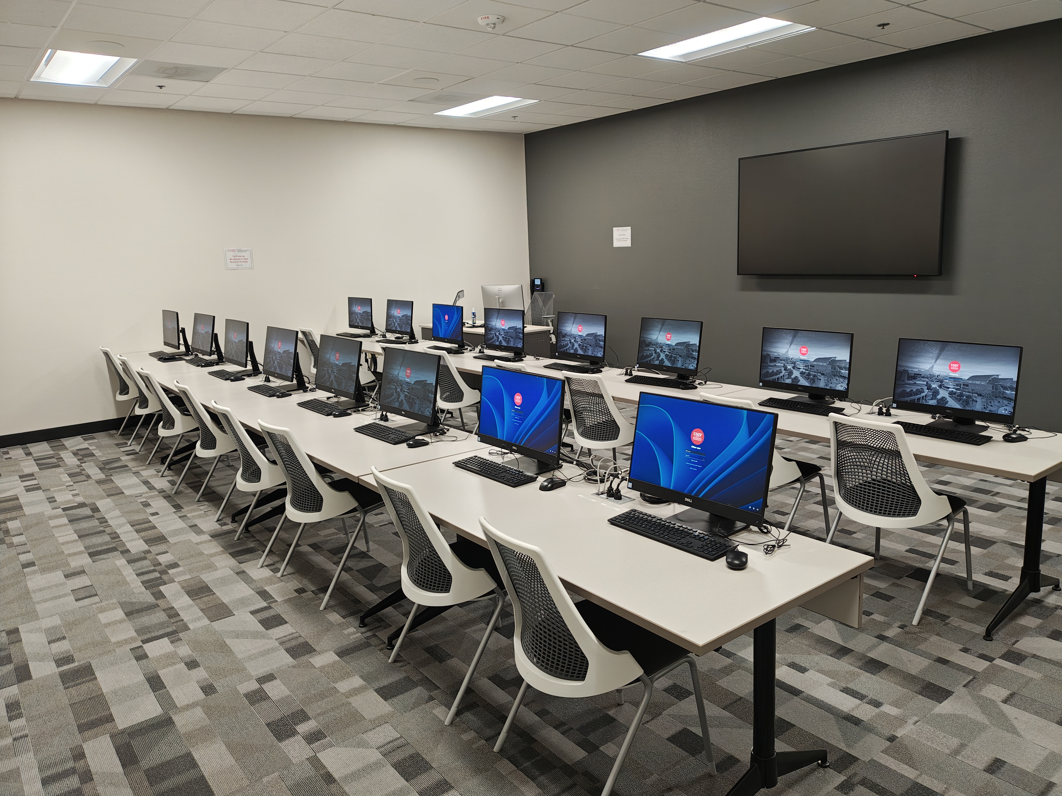 Rows of chairs and tables with computers 
