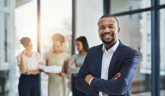 Business Administration Manager with three employees in the background