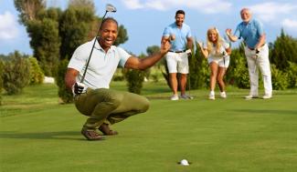 four people playing golf